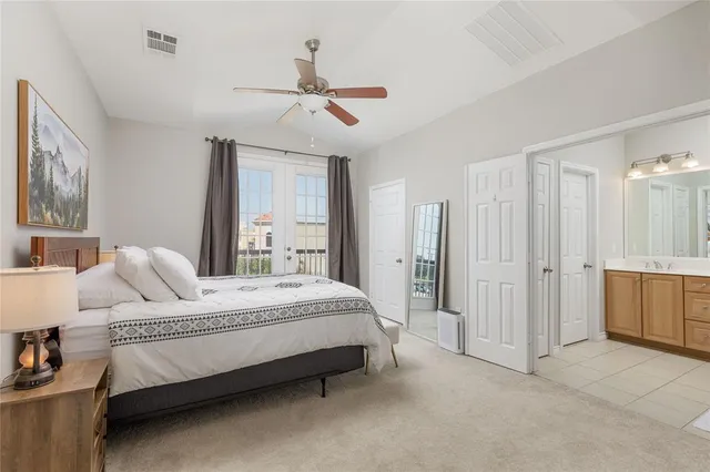 a bed room with a bed and a ceiling fan