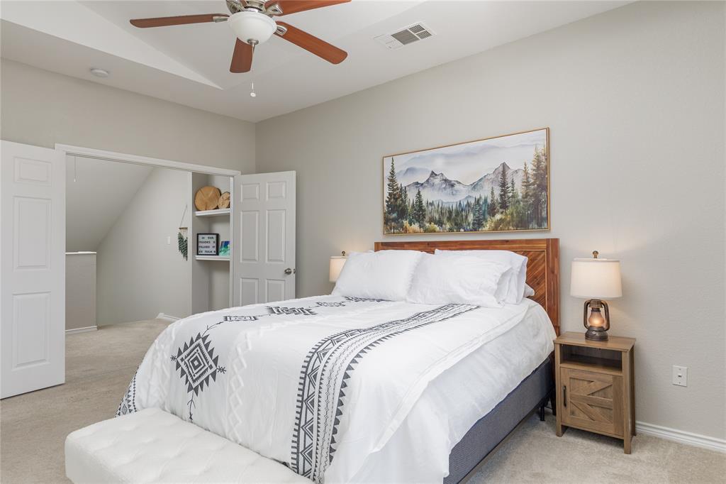 2104 Azure Pointe Richardson, TX 75080 - Photo 16 of 28 a bedroom with a large bed and a chandelier