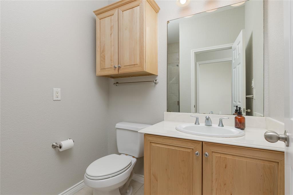 2104 Azure Pointe Richardson, TX 75080 - Photo 21 of 28 a bathroom with a sink a toilet and vanity