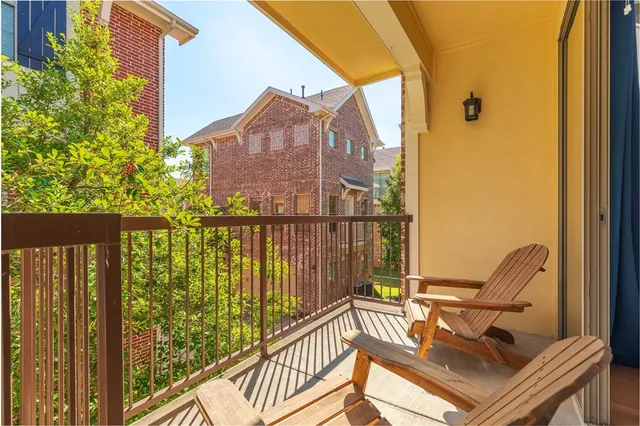a view of balcony with two chairs and a potted plant