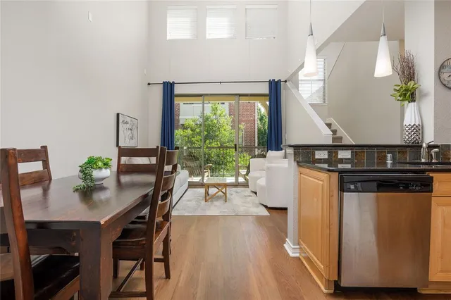 a living room with a table chairs and a potted plant