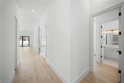 a view of a hallway with a wooden floor