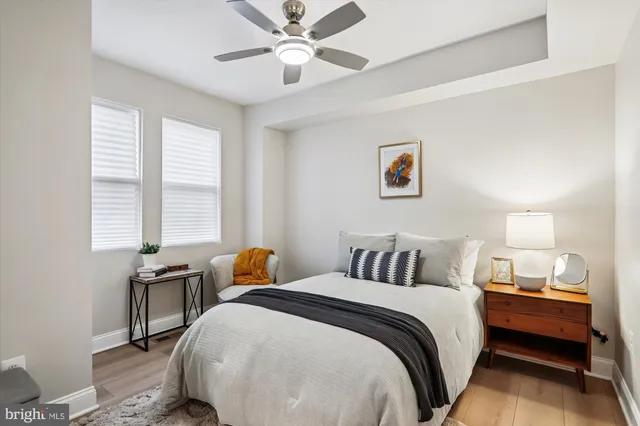 a bedroom with a bed and wooden floor