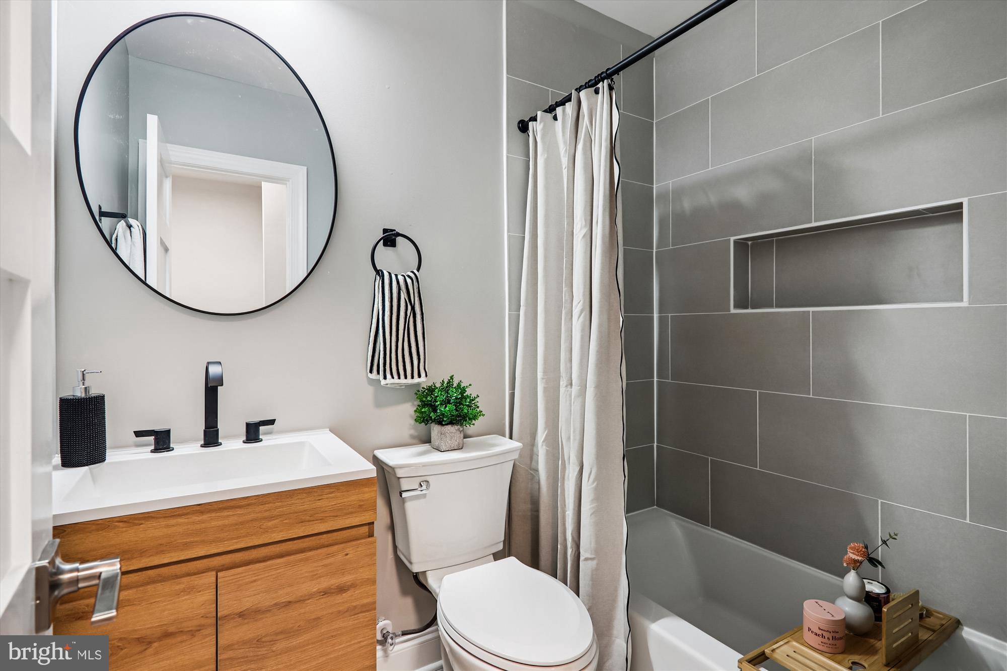 1374 Rittenhouse Street Northwest Washington, DC 20011 - Photo 14 of 30 a bathroom with a sink a toilet and a mirror