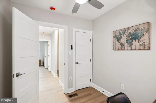a view of a hallway with wooden floor