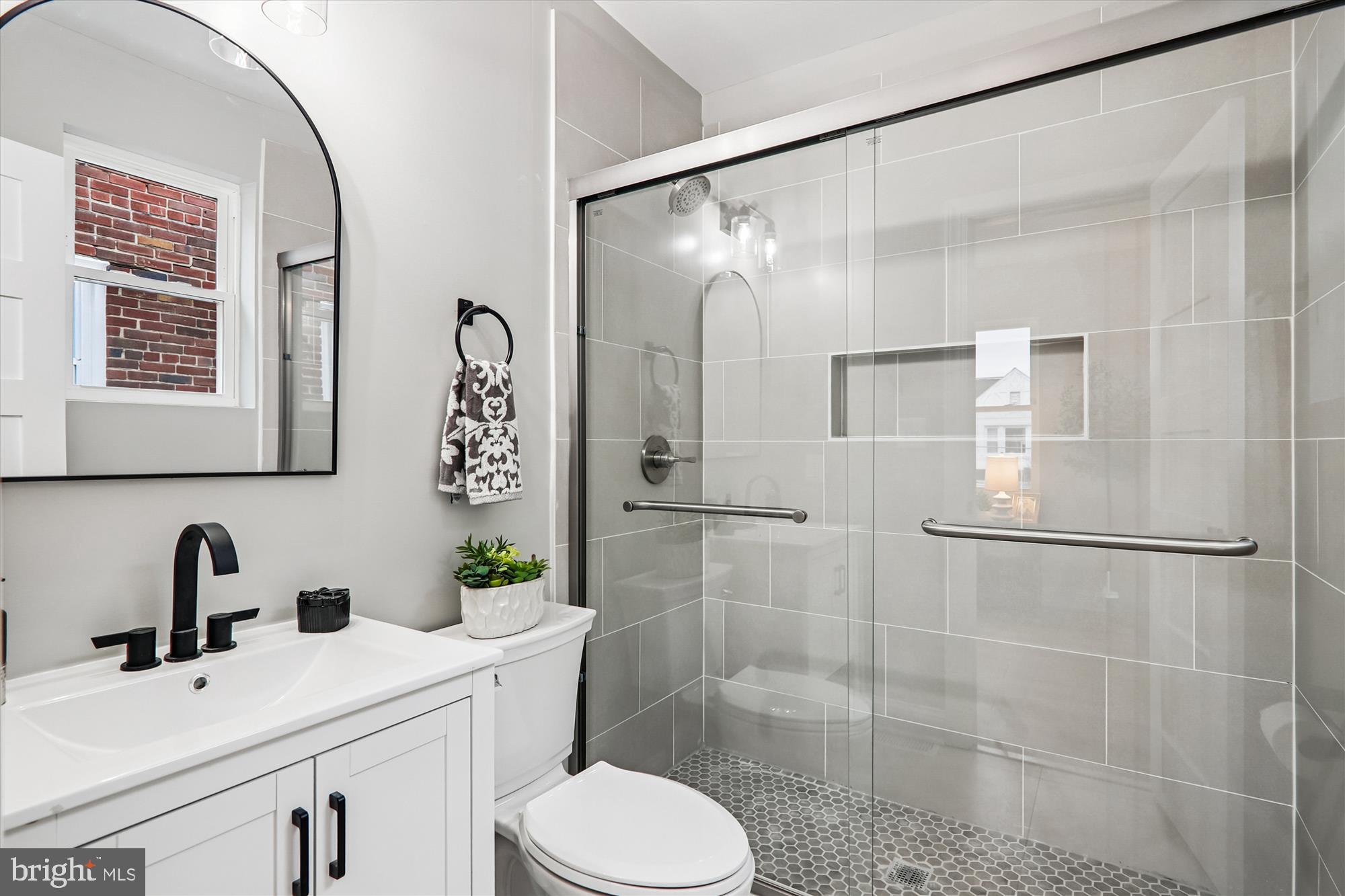 1374 Rittenhouse Street Northwest Washington, DC 20011 - Photo 17 of 30 a bathroom with a sink toilet and shower