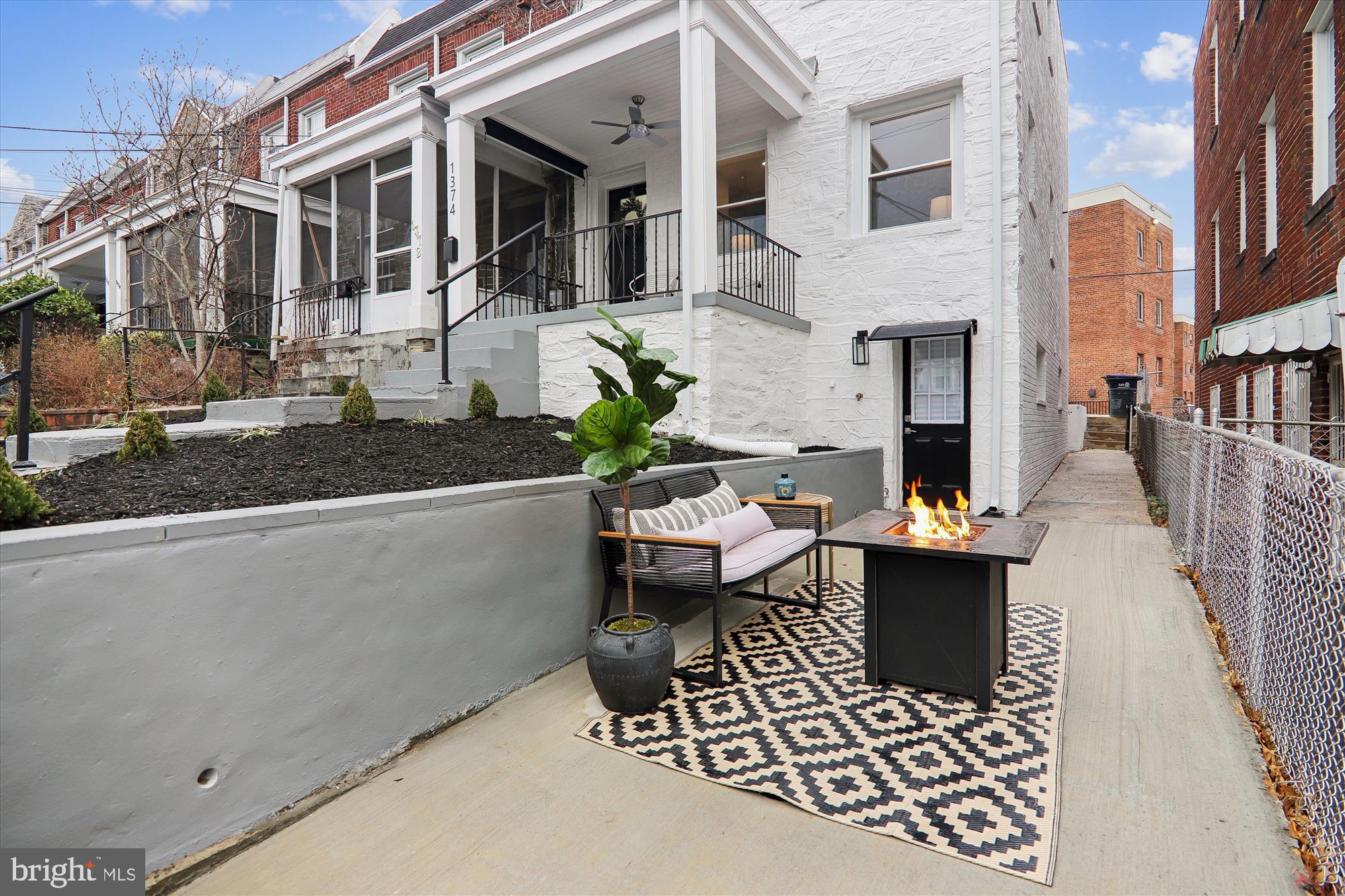 1374 Rittenhouse Street Northwest Washington, DC 20011 - Photo 2 of 30 a view of a patio with couches table and chairs and potted plants