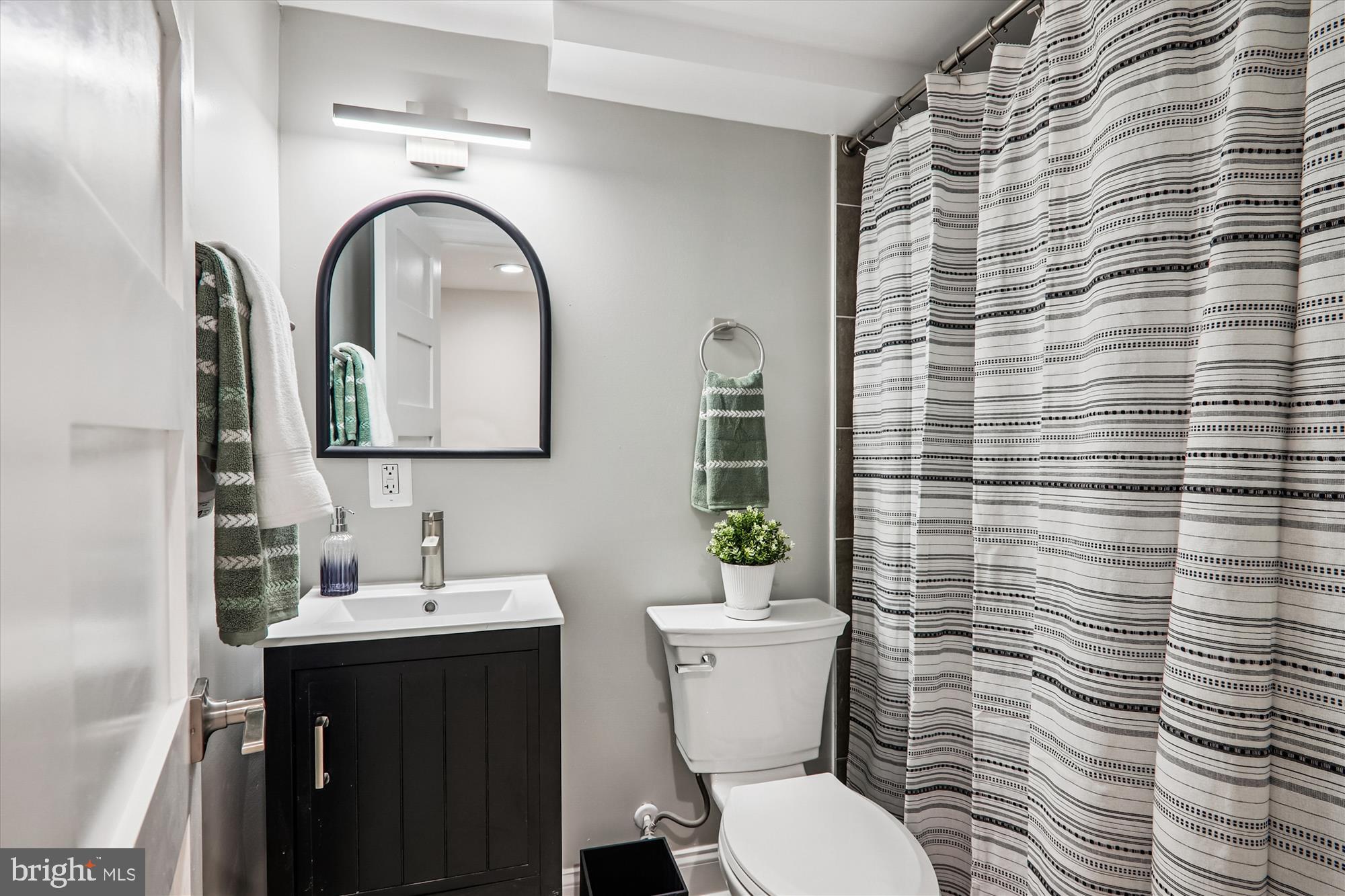 1374 Rittenhouse Street Northwest Washington, DC 20011 - Photo 21 of 30 a bathroom with a toilet a sink and mirror