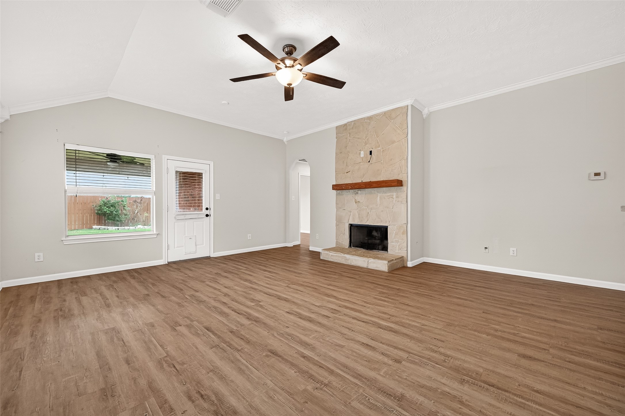 5517 Autumn Ash Lane Rosharon, TX 77583 - Photo 11 of 50 an empty room with wooden floor a ceiling fan and a window