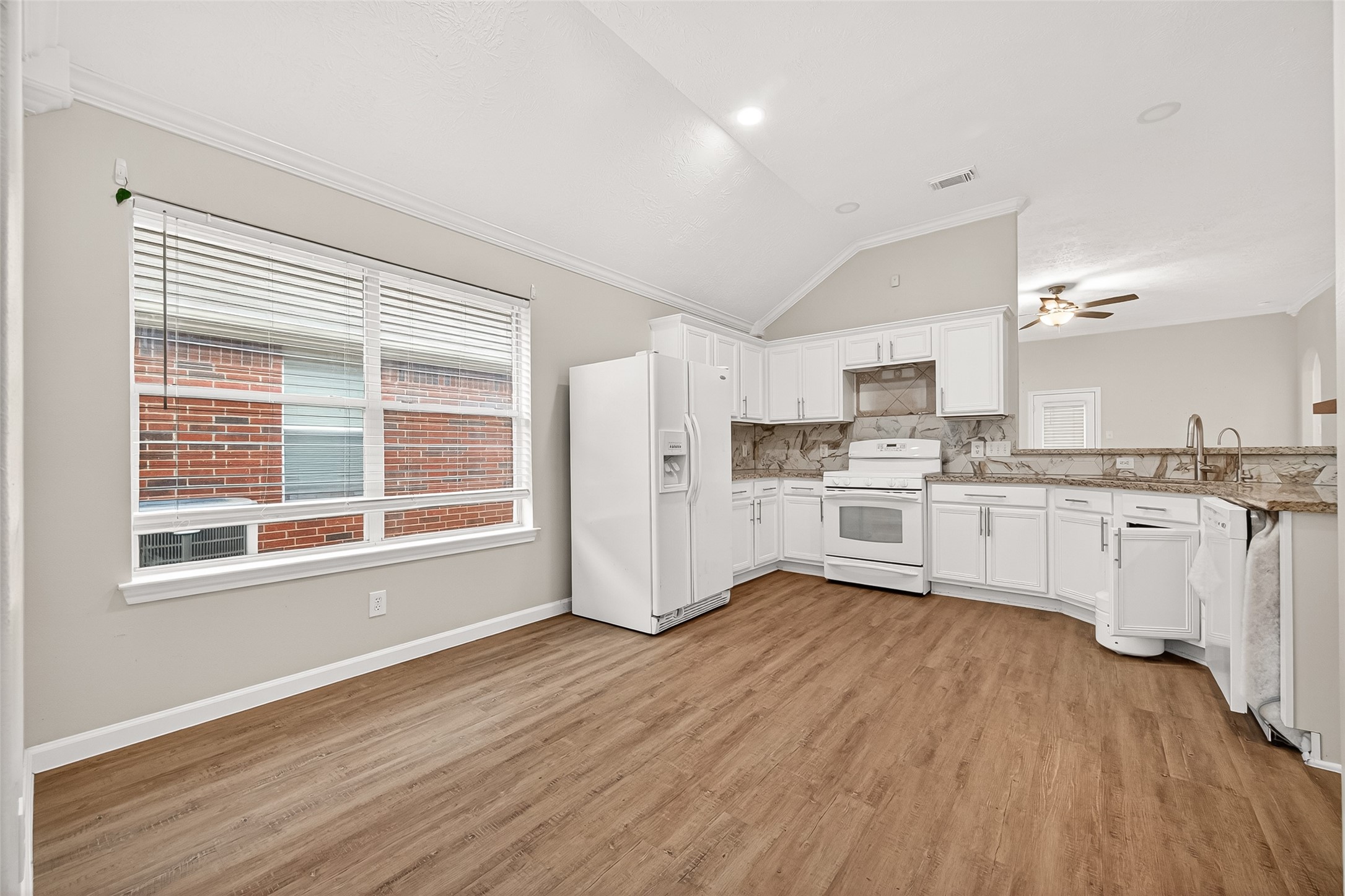 5517 Autumn Ash Lane Rosharon, TX 77583 - Photo 15 of 50 a kitchen with wooden floors and white appliances