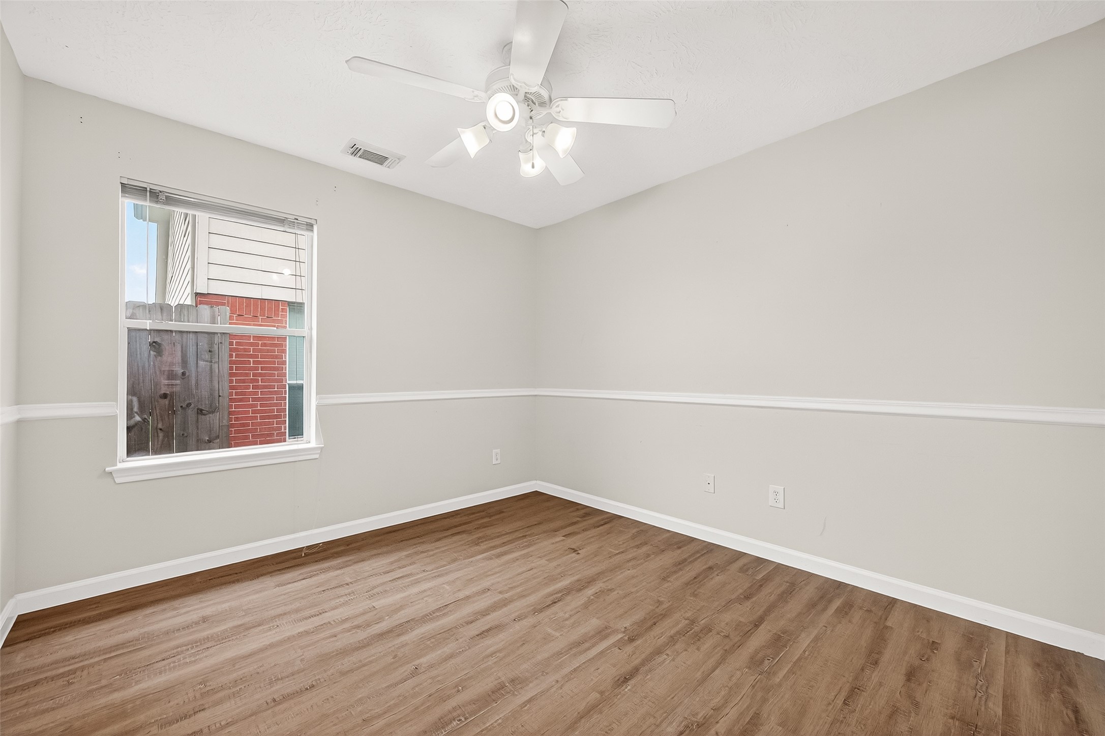 5517 Autumn Ash Lane Rosharon, TX 77583 - Photo 35 of 50 an empty room with wooden floor and windows