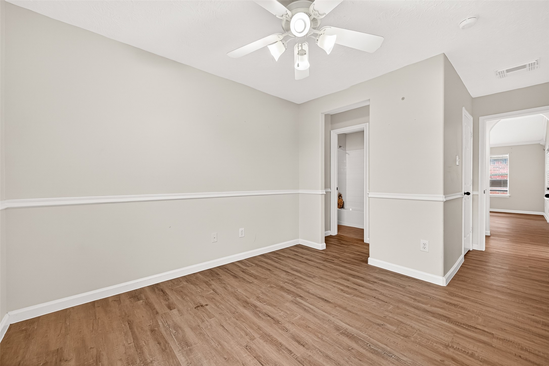 5517 Autumn Ash Lane Rosharon, TX 77583 - Photo 36 of 50 an empty room with wooden floor and ceiling fan