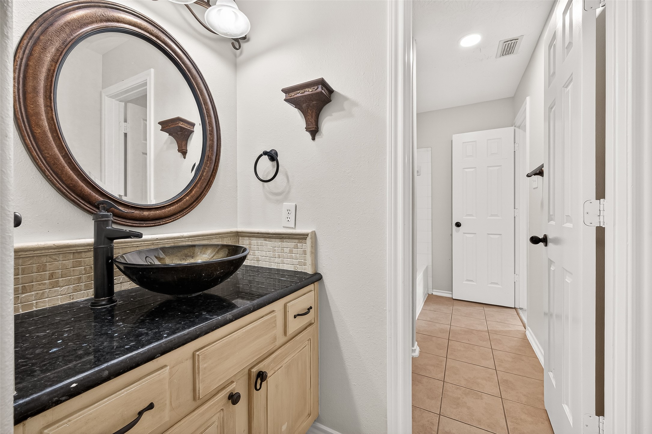 5517 Autumn Ash Lane Rosharon, TX 77583 - Photo 40 of 50 a bathroom with a granite countertop sink a mirror and vanity