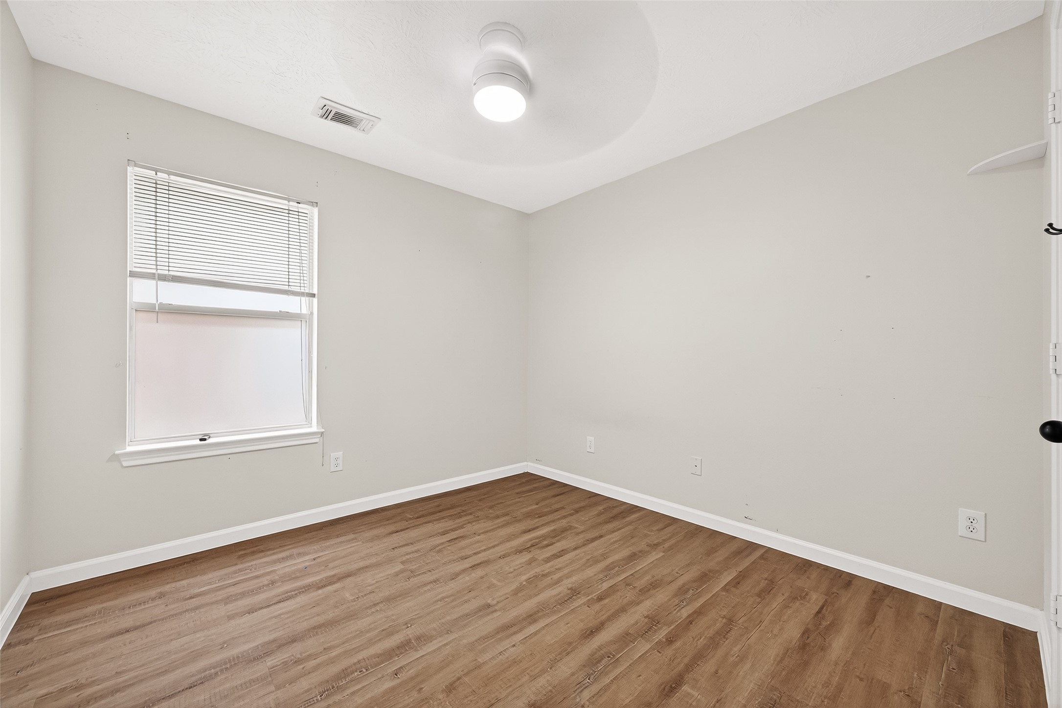 5517 Autumn Ash Lane Rosharon, TX 77583 - Photo 41 of 50 an empty room with wooden floor and windows