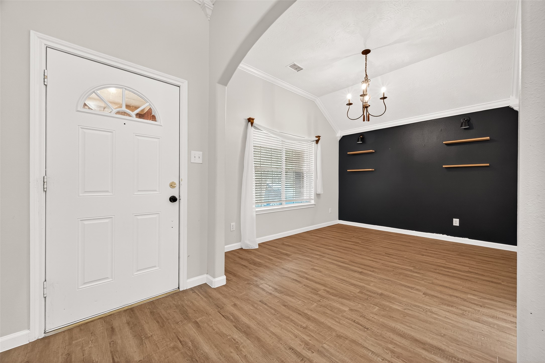 5517 Autumn Ash Lane Rosharon, TX 77583 - Photo 6 of 50 a view of an empty room with wooden floor and a window