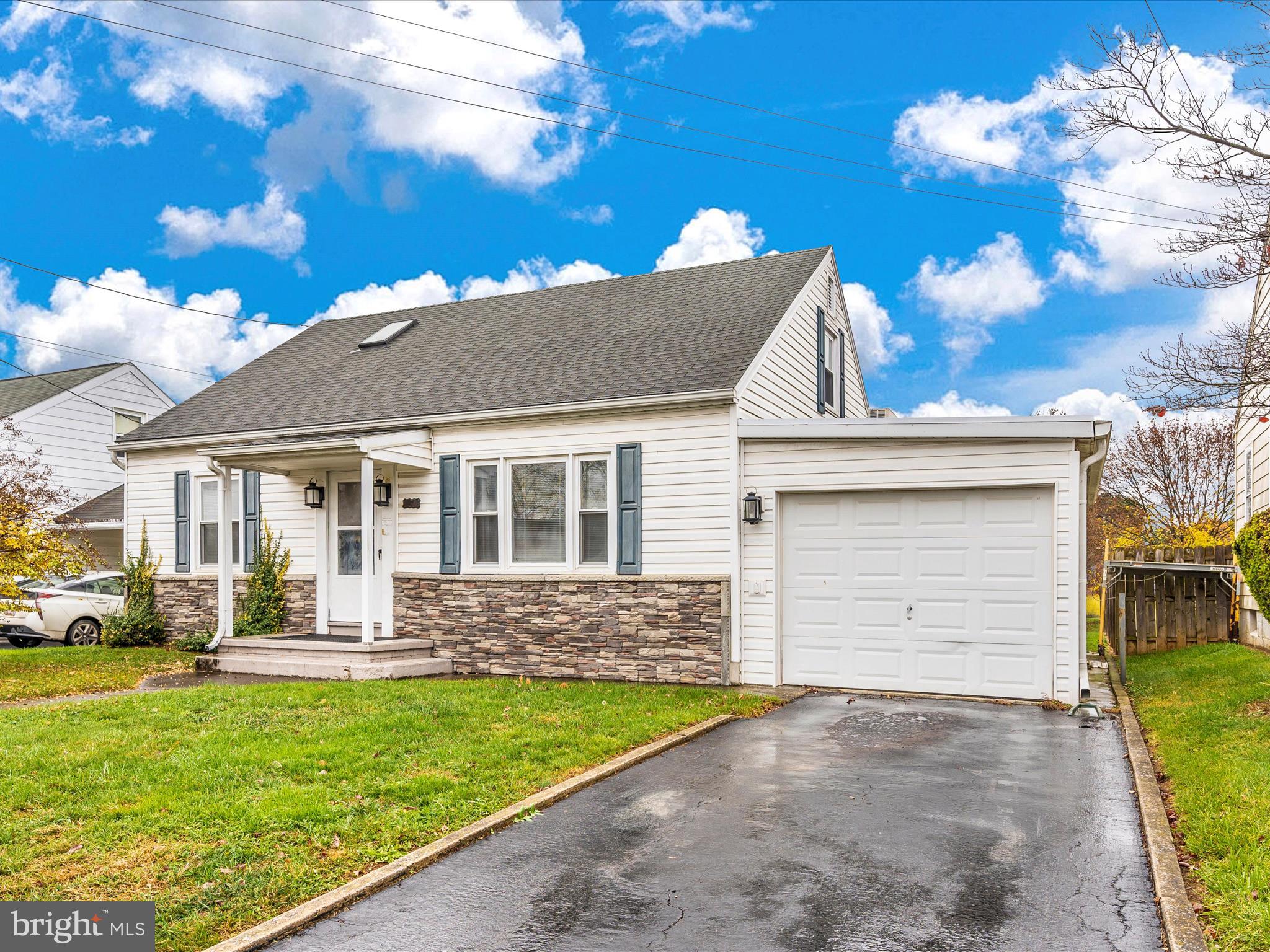 a front view of a house with a garden and yard