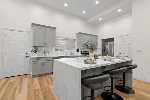 a kitchen with sink and chairs