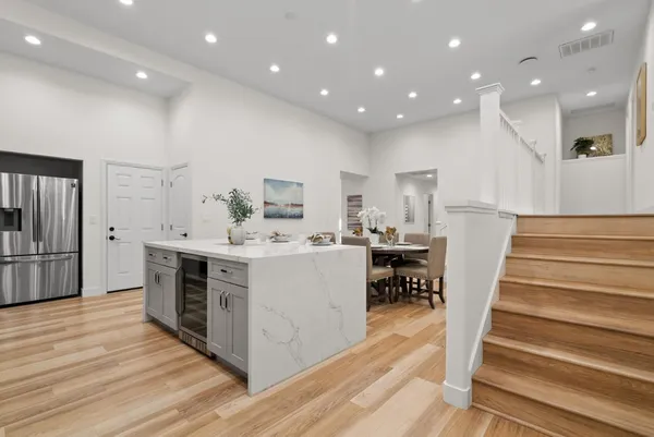 a kitchen with white cabinets and stainless steel appliances