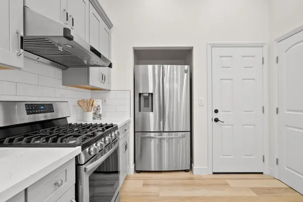 a kitchen with cabinets and a stove top oven
