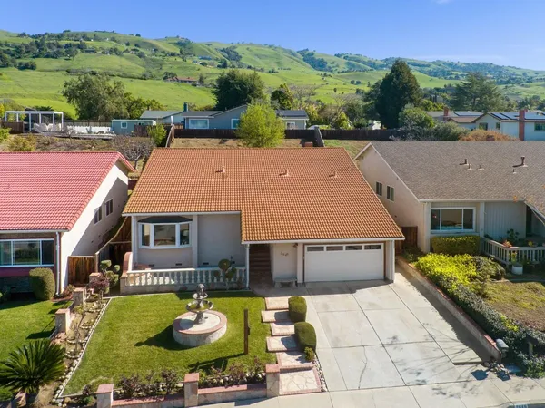 an aerial view of a house with yard swimming pool and outdoor seating