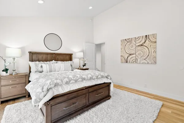 a bed sitting in a bedroom next to a lamp