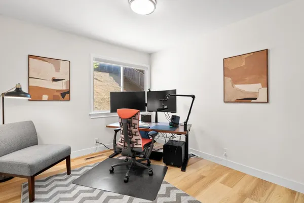 a work room with furniture and wooden floor