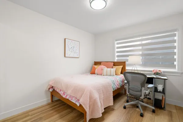 a bedroom with a bed and a desk