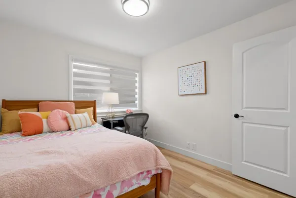 a bedroom with a bed and window