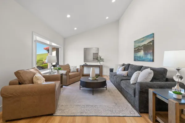 a living room with furniture and a large window