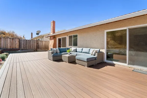 a balcony with furniture and a wooden floor