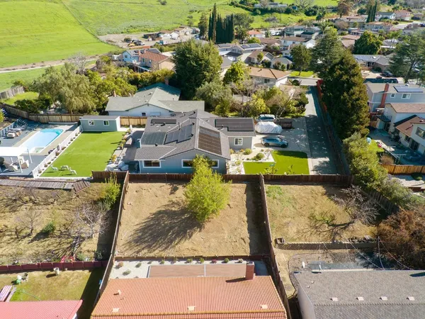 an aerial view of a house with a swimming pool