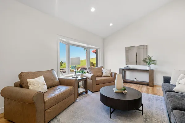 a living room with furniture and a potted plant
