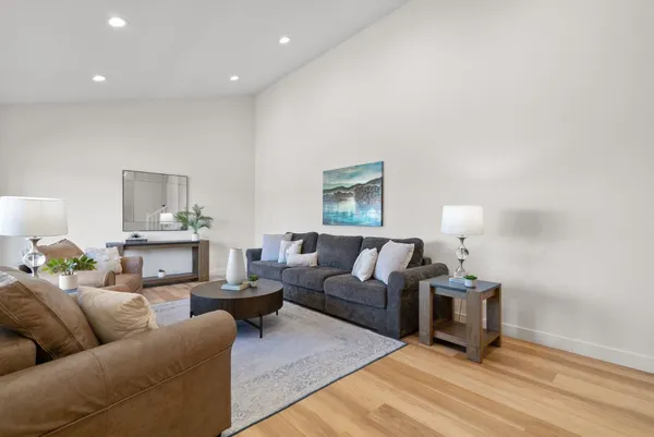 a living room with furniture and a wooden floor