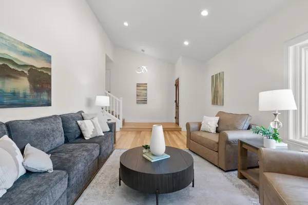 a living room with furniture and a potted plant