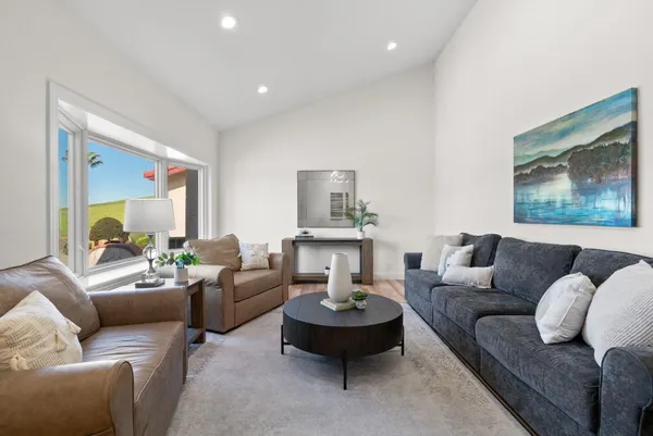 a living room with furniture and a large window