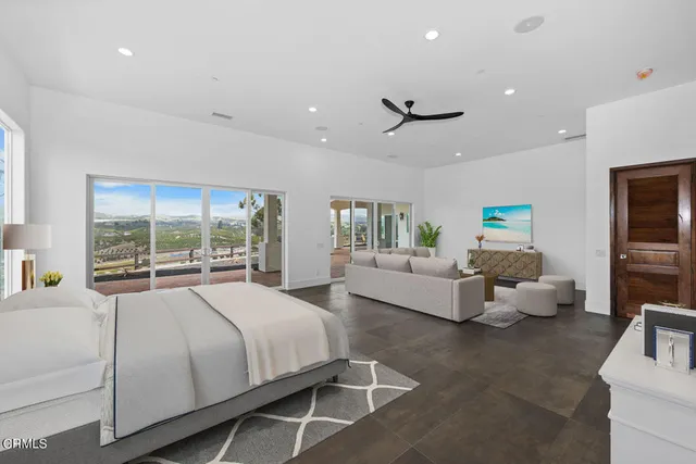 a spacious bedroom with a bed and large window