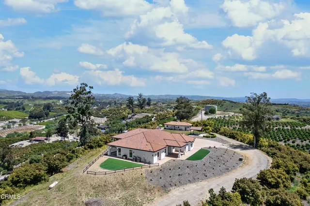 an aerial view of a house having yard patio and swimming pool