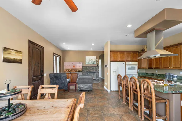 a bathroom with a granite countertop sink toilet a mirror and shower