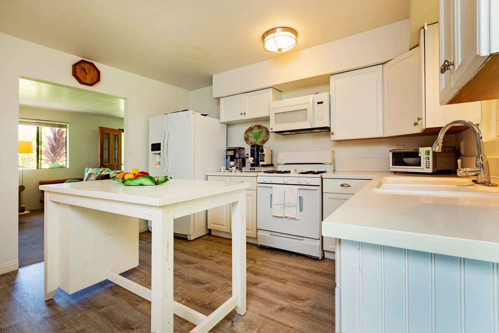 44 North Honokala Road Haiku, HI 96708 - Photo 3 of 30 a kitchen with white cabinets and appliances