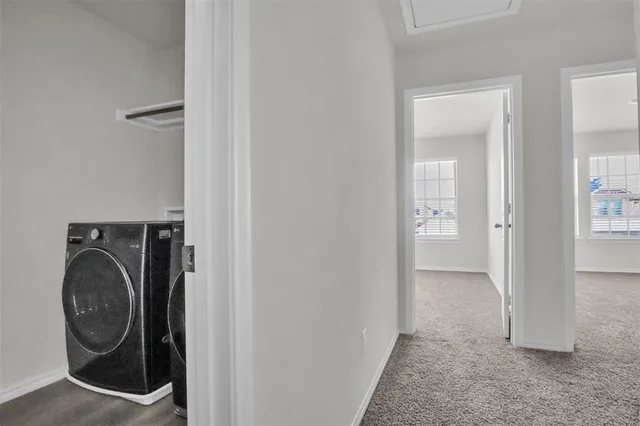a view of a hallway with washer and dryer