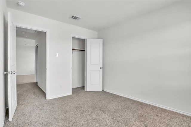 a view of an empty room and closet area