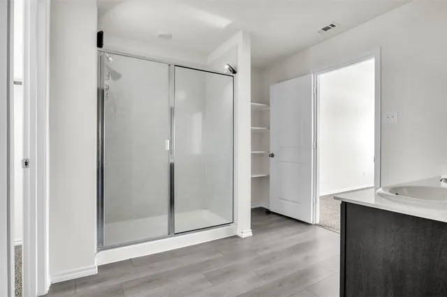 a view of a bathroom with a shower and a sink
