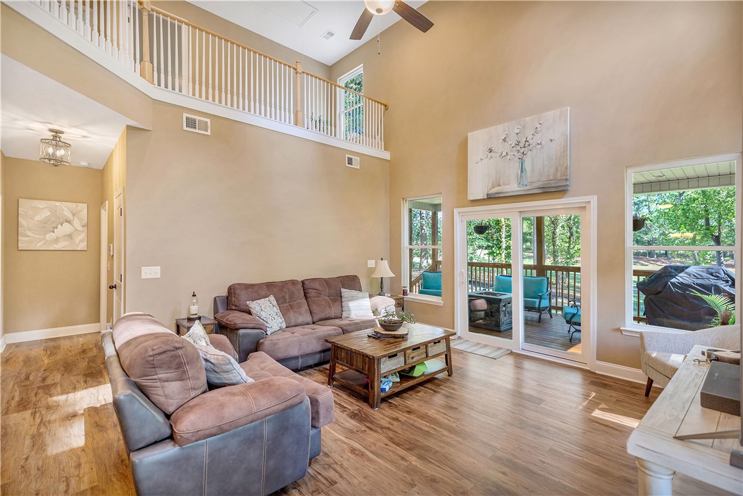 3004 Cobbs Way Anderson, SC 29621 - Photo 10 of 46 Towering ceilings and rich hardwood floors anchors this light-filled main living space.