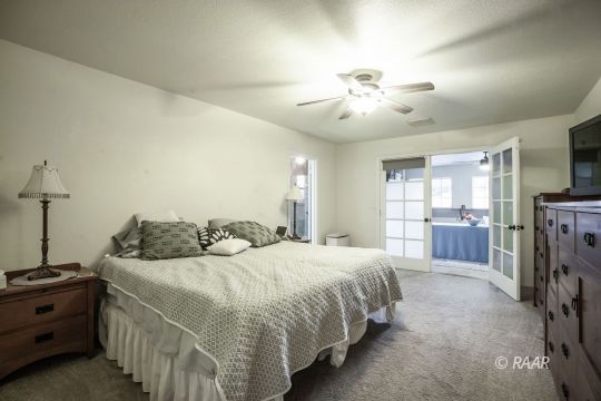 532 Amanda Street Ridgecrest, CA 93555 - Photo 17 of 35 a bedroom with a bed and a chandelier