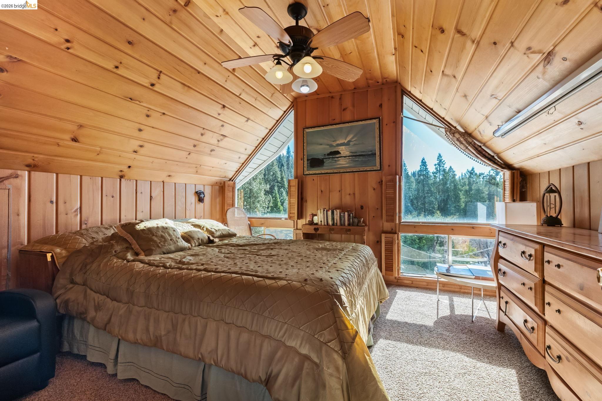 26039 Long Barn Road Long Barn, CA 95335 - Photo 4 of 27 Bedroom with wooden ceiling, wooden walls, light colored carpet, lofted ceiling, and a ceiling fan
