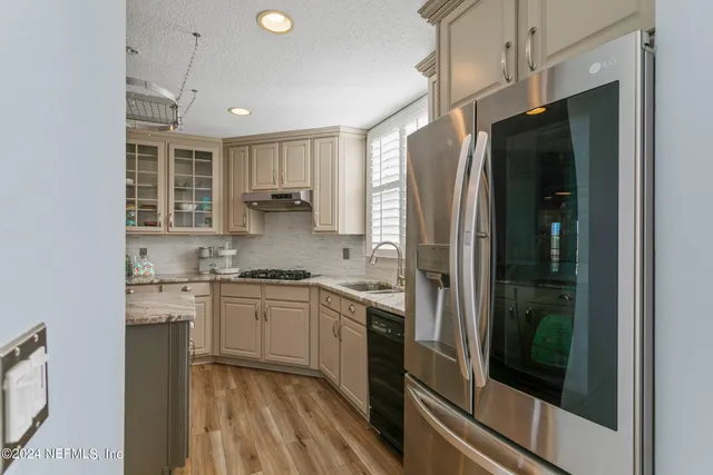 a living room with furniture a large window and a fireplace