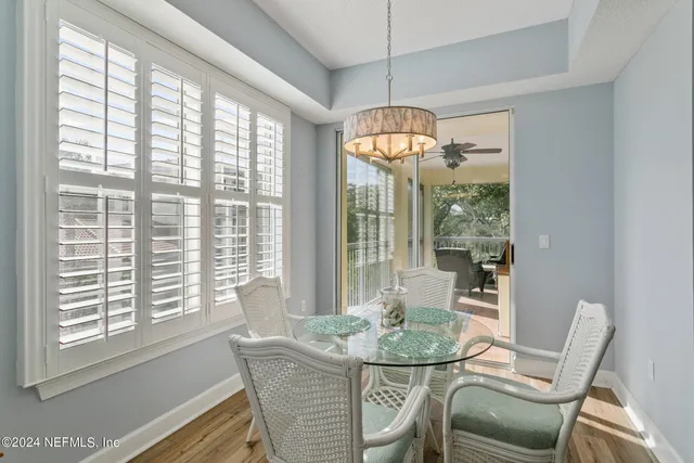 a kitchen with a dining table wooden floor and kitchen view