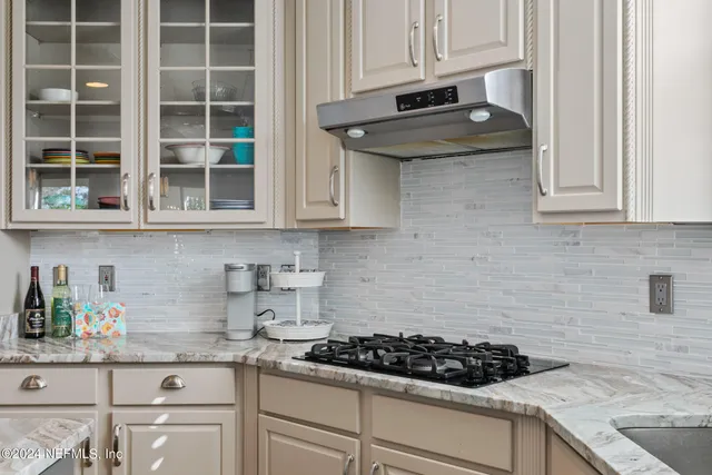 a spacious bathroom with a granite countertop sink and a mirror