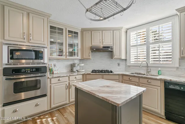 a bathroom with a granite countertop sink mirror and double