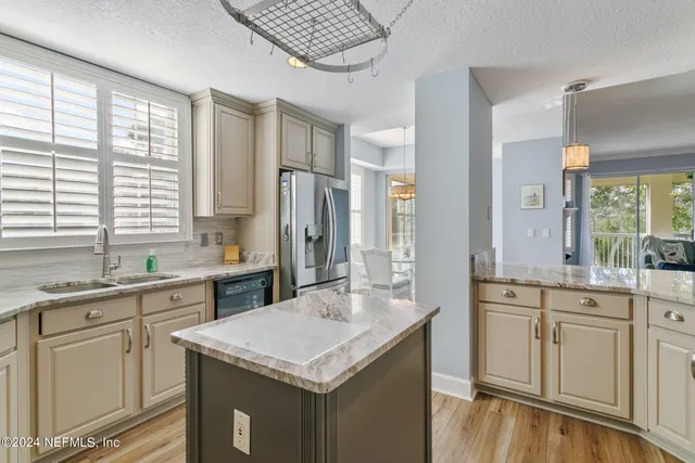a living room with a chair and large window